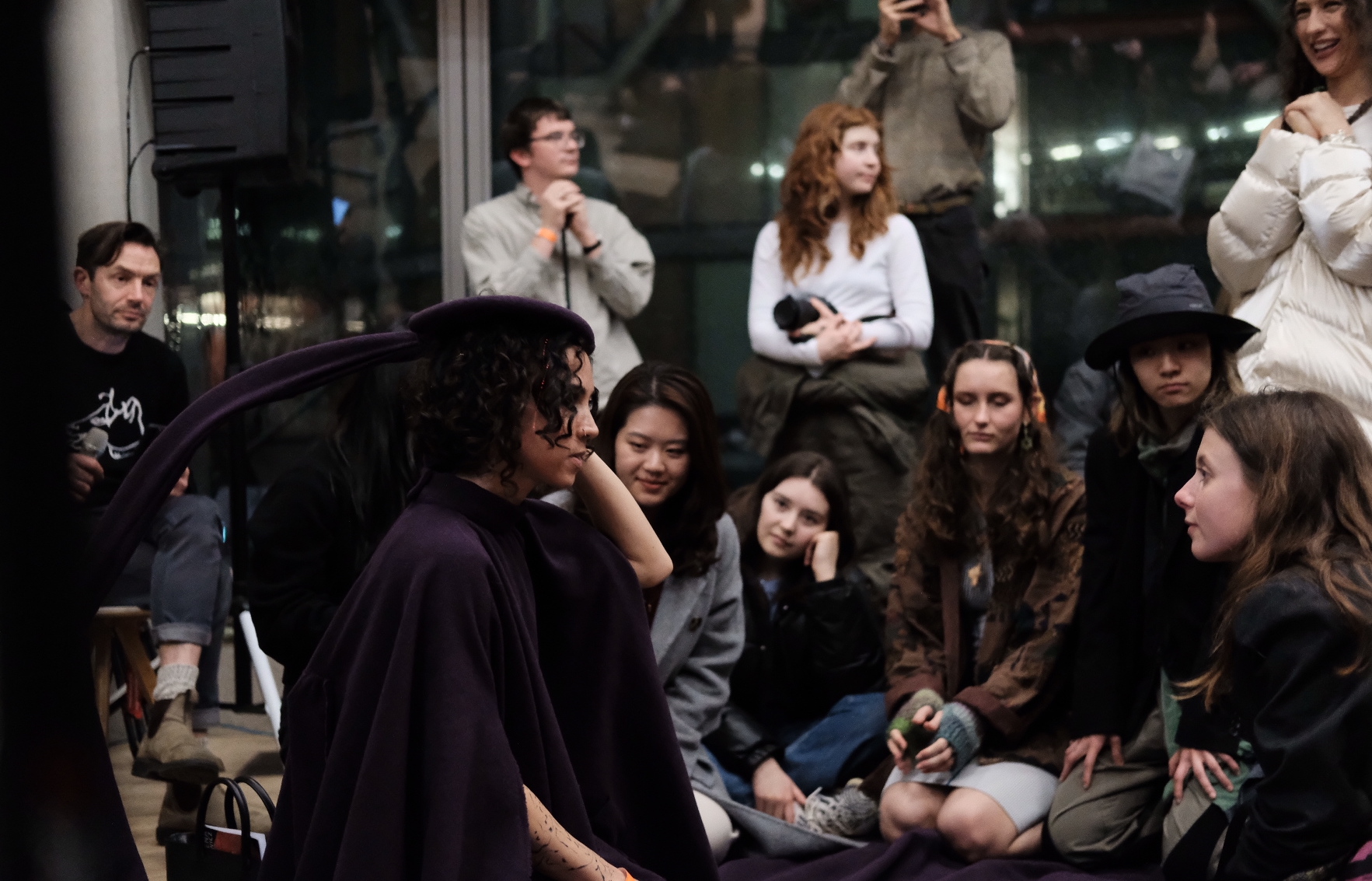 Pneuma — a performer in deep purple surrounded by an intimate circle of participants at Tate Late