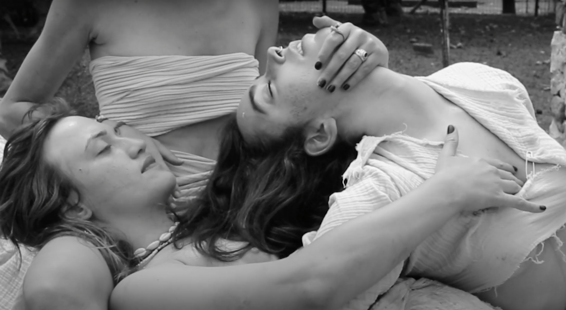 Body as Battlefield workshop — two performers lying close together outdoors, black and white